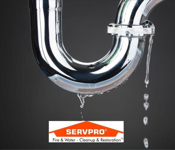 Acloseup of a silver pipe with water coming out of it and the SERVPRO logo at the bottom
