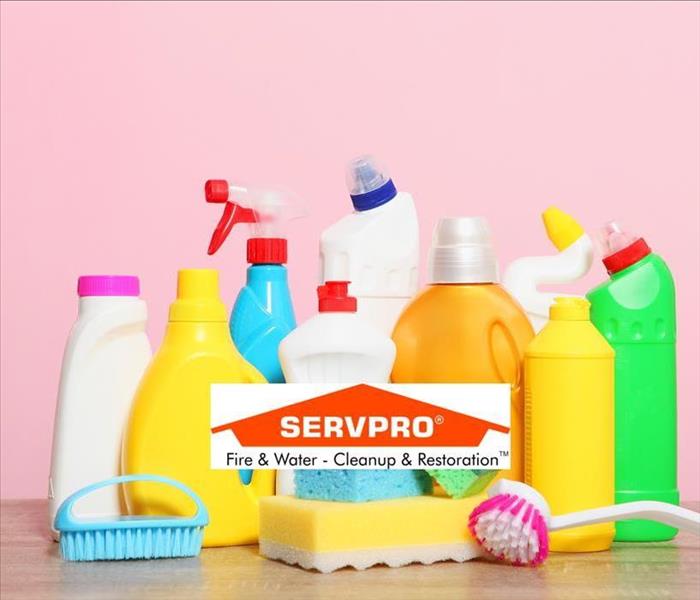 A pink background with a bunch of no-name bottles of cleaning supplies and the SERVPRO logo at the bottom