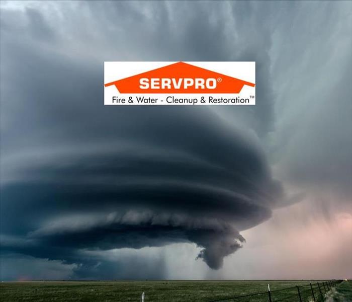 A sky with a tornado forming and the SERVPRO logo at the top